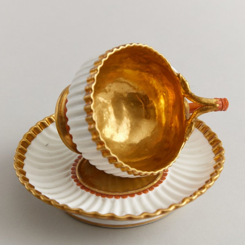 Старинная фарфоровая чашка в форме раковины с блюдцем
